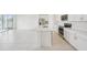 Well-lit kitchen featuring a kitchen island with stainless steel appliances and tile flooring at 1817 Draughton Dr, Zephyrhills, FL 33541