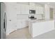 Bright kitchen featuring a kitchen island, stainless steel appliances, and white cabinets at 1817 Draughton Dr, Zephyrhills, FL 33541
