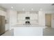 Bright kitchen featuring a kitchen island, stainless steel appliances, and tile flooring at 1817 Draughton Dr, Zephyrhills, FL 33541