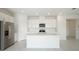 Bright kitchen featuring a kitchen island with stainless steel appliances and white cabinets at 1817 Draughton Dr, Zephyrhills, FL 33541
