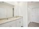 Bathroom featuring double sinks, granite countertops, and a walk-in shower at 3539 Moscato Dr, Brooksville, FL 34602