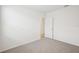 A simple bedroom features neutral walls, a doorway and carpet flooring at 3539 Moscato Dr, Brooksville, FL 34602