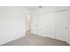 Bright bedroom with light grey carpet, closet and white walls providing a serene atmosphere at 3539 Moscato Dr, Brooksville, FL 34602