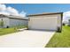 This home features a wide driveway leading to a two-car garage for parking at 3539 Moscato Dr, Brooksville, FL 34602