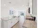 Open-concept kitchen showcasing a central island, granite countertops, and stainless dishwasher at 3539 Moscato Dr, Brooksville, FL 34602