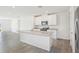 Modern kitchen features a large island with granite countertops and stainless steel appliances at 3539 Moscato Dr, Brooksville, FL 34602