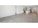 Spacious living room with tile floors, leading to the kitchen with stainless steel appliances at 3539 Moscato Dr, Brooksville, FL 34602