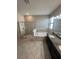 Primary bathroom with a double sink vanity, granite countertops, and a separate shower and tub at 13244 Satin Lily Dr, Riverview, FL 33579