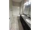 Elegant bathroom featuring double vanity with granite countertop, tile flooring, and a shower-tub combination at 13244 Satin Lily Dr, Riverview, FL 33579