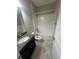 Bathroom featuring a single sink vanity, tiled floor, and shower over tub at 13244 Satin Lily Dr, Riverview, FL 33579