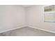 Neutral carpeted bedroom features a window and freshly painted walls at 13244 Satin Lily Dr, Riverview, FL 33579