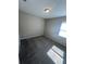 A sunlit bedroom with plush gray carpeting, neutral walls, and a bright window creates a cozy atmosphere at 13244 Satin Lily Dr, Riverview, FL 33579