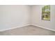 Neutral carpeted bedroom features a window and freshly painted walls at 13244 Satin Lily Dr, Riverview, FL 33579