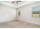 Bright bedroom featuring plush carpeting, a tray ceiling and large windows that flood the room with light at 13244 Satin Lily Dr, Riverview, FL 33579