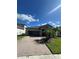 Charming single-Gathering home with stone accents, a brick driveway, and tropical landscaping at 13244 Satin Lily Dr, Riverview, FL 33579