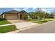 Charming single-story home featuring a brick-paved driveway and a well-manicured lawn at 13244 Satin Lily Dr, Riverview, FL 33579