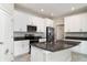 Well-equipped kitchen featuring stainless steel appliances, white cabinets, and a center island at 13244 Satin Lily Dr, Riverview, FL 33579