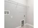 Tile-floored laundry room featuring hook-ups, shelf and neutral-painted walls at 13244 Satin Lily Dr, Riverview, FL 33579
