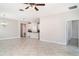 Spacious open floor plan with tile flooring seamlessly connecting the living area to the kitchen at 13244 Satin Lily Dr, Riverview, FL 33579