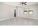 Bright living room with tile flooring, a ceiling fan, and a door to the backyard at 13244 Satin Lily Dr, Riverview, FL 33579