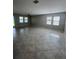Spacious living room featuring tile floors, abundant natural light, and a modern ceiling fan at 13244 Satin Lily Dr, Riverview, FL 33579