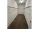 Walk-in closet with wire shelving and carpet flooring offering ample storage space at 13244 Satin Lily Dr, Riverview, FL 33579