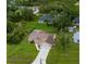 Aerial view of a well-maintained home with a spacious yard and extended driveway at 1835 Rival Ter, North Port, FL 34286
