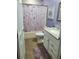 Well-lit bathroom features a tub-shower, toilet, vanity and lavender decor at 1835 Rival Ter, North Port, FL 34286