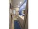 Bathroom features a modern vanity, mirror, and shower over the toilet and a blue accent wall at 1835 Rival Ter, North Port, FL 34286