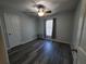 Charming bedroom featuring a ceiling fan, and wood-look laminate flooring at 1835 Rival Ter, North Port, FL 34286