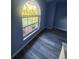 Bedroom with hardwood floors, an arched window letting in natural light, and freshly painted walls at 1835 Rival Ter, North Port, FL 34286