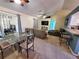 Open-concept dining area with a glass table, chairs, and views into the Gathering room at 1835 Rival Ter, North Port, FL 34286