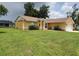 Charming single-story home with a well-manicured lawn and beautiful landscaping at 1835 Rival Ter, North Port, FL 34286