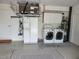 Neat garage space with modern washer and dryer, alongside a full-sized refrigerator at 1835 Rival Ter, North Port, FL 34286