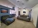 Living room featuring neutral carpet, sofas, and a wet bar with room for barstool seating at 1835 Rival Ter, North Port, FL 34286