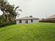 A modest backyard features a simple design and ample greenery at 3805 N Cranberry Blvd, North Port, FL 34286