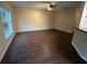 Open-concept living room showcasing wood flooring and access to the kitchen area at 3805 N Cranberry Blvd, North Port, FL 34286