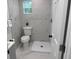 Modern bathroom with a marble-tiled shower, new toilet, and stylish fixtures at 38706 8Th Ave, Zephyrhills, FL 33542