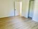 Bright bedroom featuring light wood flooring, closet, and white trim throughout at 38706 8Th Ave, Zephyrhills, FL 33542