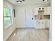 Efficient kitchen area with white cabinets, stainless steel faucet, and laminate flooring at 38706 8Th Ave, Zephyrhills, FL 33542