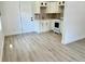 Bright kitchen featuring white cabinets, a new stove, and laminate flooring at 38706 8Th Ave, Zephyrhills, FL 33542