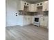 Updated kitchen featuring white cabinets, stainless steel appliances, and light countertops at 38706 8Th Ave, Zephyrhills, FL 33542
