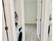 Hallway view of laundry area with stackable washer/dryer and adjacent bedroom at 38706 8Th Ave, Zephyrhills, FL 33542