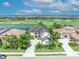 An aerial view of a home showcases its position near a golf course and lake community at 5531 Arnie Loop, Bradenton, FL 34211