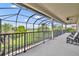 Large screened-in balcony with patio furniture overlooking the lush golf course at 5531 Arnie Loop, Bradenton, FL 34211