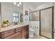 Bathroom featuring a granite sink, toilet, and frameless glass walk-in shower at 5531 Arnie Loop, Bradenton, FL 34211