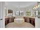 Lavish bathroom featuring a large soaking tub with dark wood cabinetry at 5531 Arnie Loop, Bradenton, FL 34211