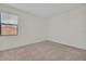 Empty room with neutral walls and carpet, plus a window for natural light at 5531 Arnie Loop, Bradenton, FL 34211