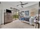 Bedroom with a ceiling fan and access to a screened-in balcony that has beautiful views of the area at 5531 Arnie Loop, Bradenton, FL 34211