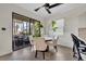 Bright dining area with a marble table, cushioned chairs, and sliding glass door to the lanai at 5531 Arnie Loop, Bradenton, FL 34211